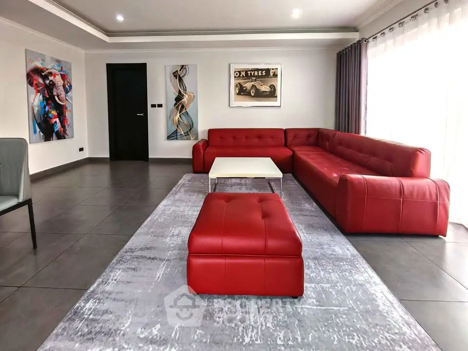 Spacious modern living room with red sectional sofa and stylish decor
