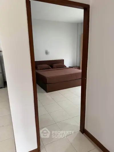 Spacious bedroom with modern decor and cozy ambiance in a stylish apartment.