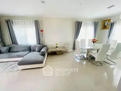 Spacious living and dining area with modern furniture and natural light