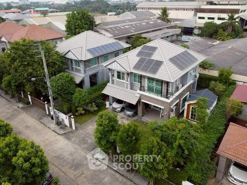 Modern suburban homes with solar panels and lush greenery in a peaceful neighborhood.
