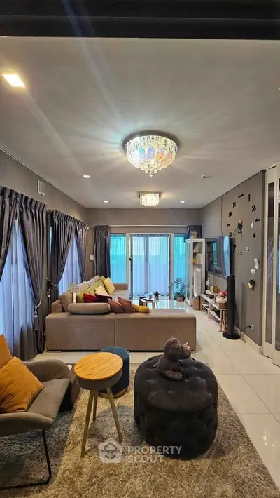 Spacious living room with elegant decor and large windows for natural light