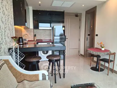 Modern kitchen with sleek black cabinets and cozy dining area