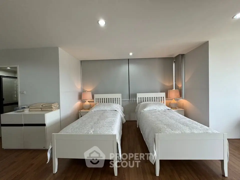 Spacious bedroom with twin beds and modern decor