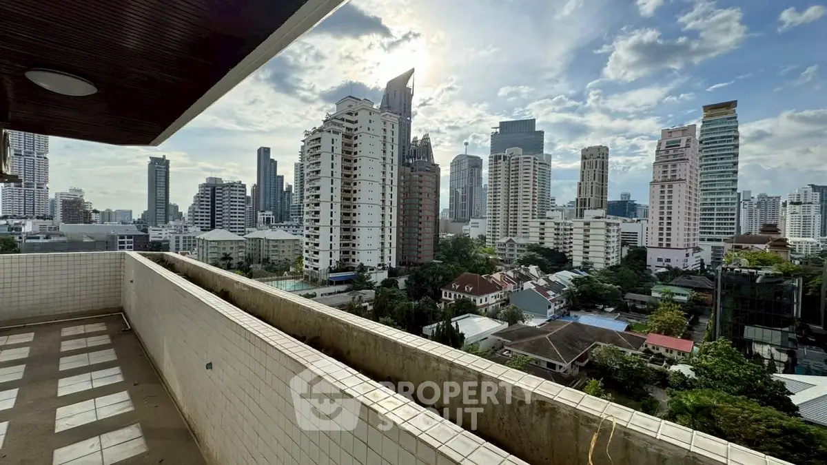 Stunning cityscape view from a spacious balcony in a high-rise building, perfect for urban living.
