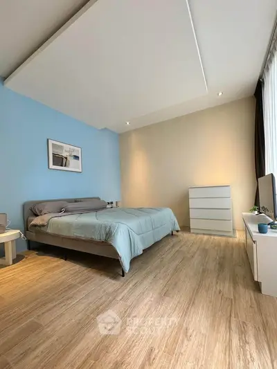 Spacious modern bedroom with stylish decor and natural light
