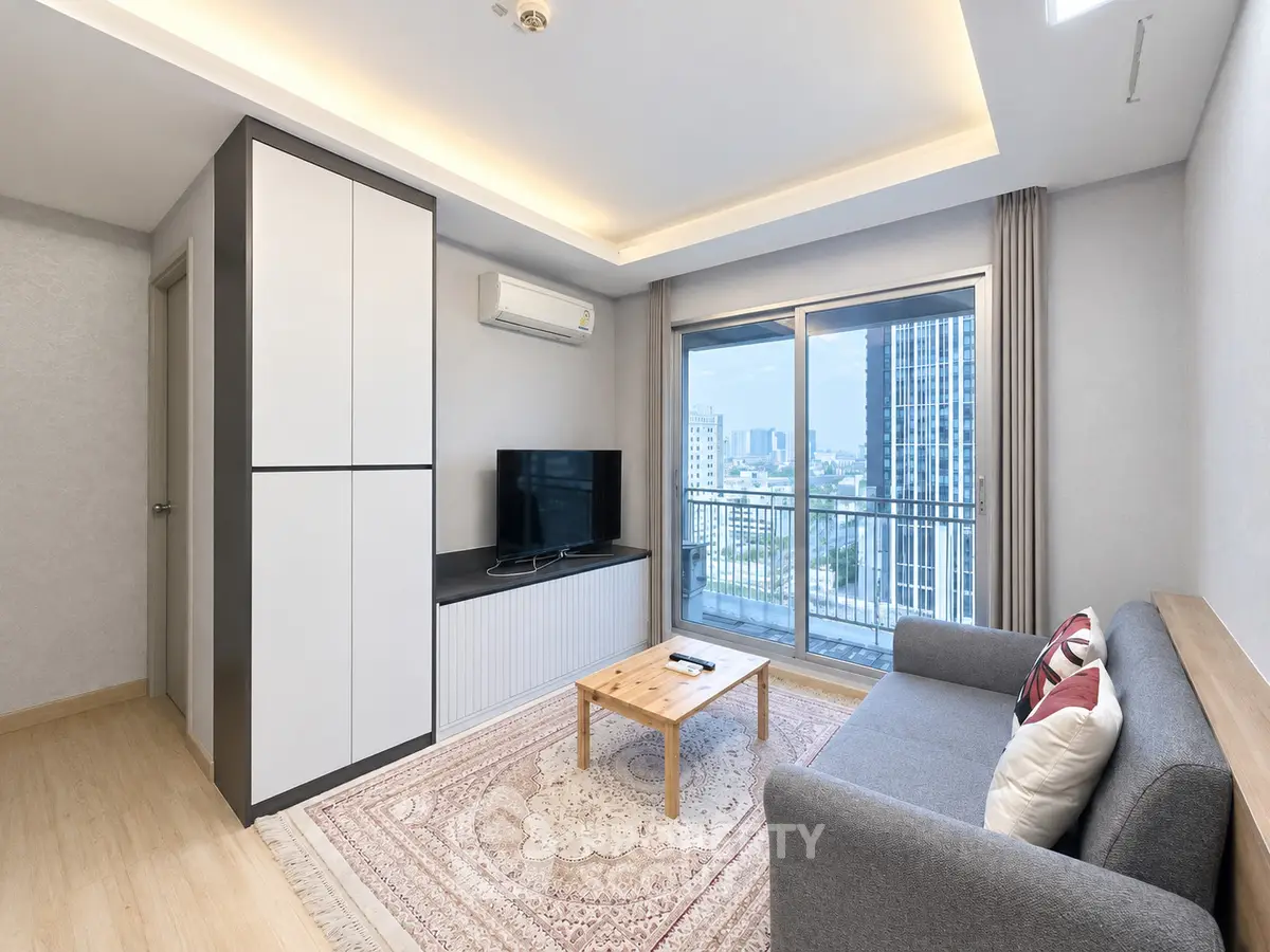 Modern living room with city view, featuring a cozy sofa and stylish decor.