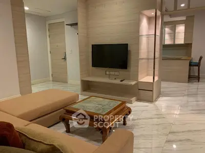 Spacious living room with modern decor and open kitchen layout