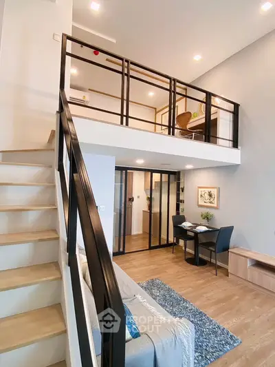 Modern loft apartment with mezzanine, stylish interior design, and open living space.