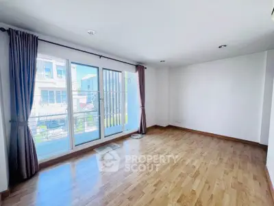 Spacious empty living room with large windows and wooden flooring