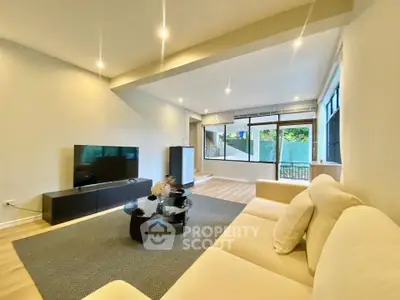 Spacious modern living room with large windows and elegant decor