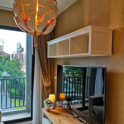 Modern living room with stylish lighting and balcony view in urban apartment.