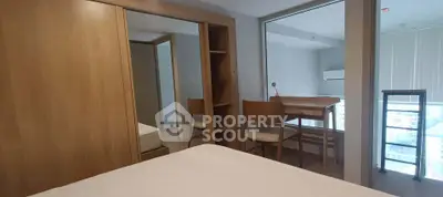 Modern bedroom with wooden wardrobe and study area in a stylish apartment