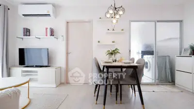 Modern living room with dining area and washing machine, featuring stylish lighting and air conditioning.
