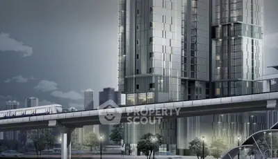 Modern high-rise building with sleek design near urban transit line.