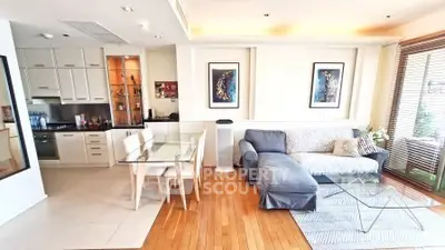 Modern open-layout living room with stylish kitchen and cozy seating area.