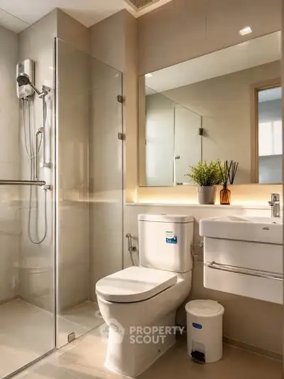 Modern bathroom with glass shower, sleek fixtures, and elegant lighting.