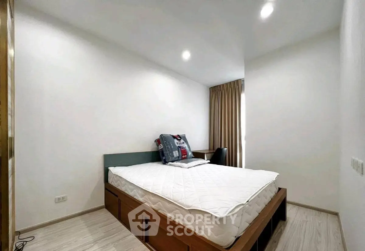 Modern minimalist bedroom with cozy bed and natural light