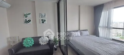 Modern bedroom with large windows and cozy decor in a high-rise apartment.