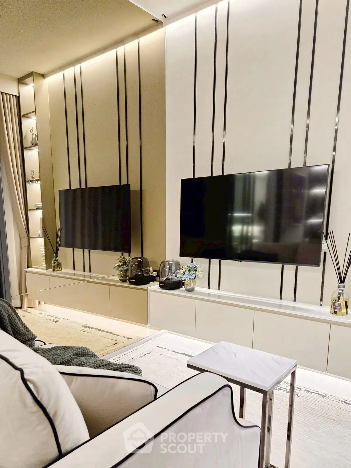 Luxurious modern living room with dual TVs and elegant decor