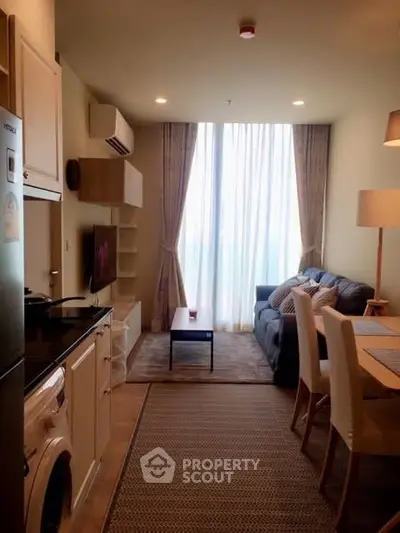 Cozy living room with modern kitchen and natural light