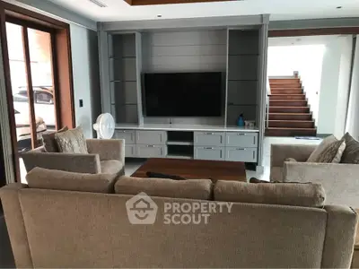 Spacious living room with modern furniture and entertainment center