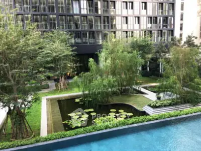 Luxurious apartment building with serene garden and pool view