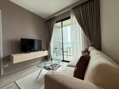 Modern living room with cozy sofa, glass coffee table, and balcony view in a stylish apartment.