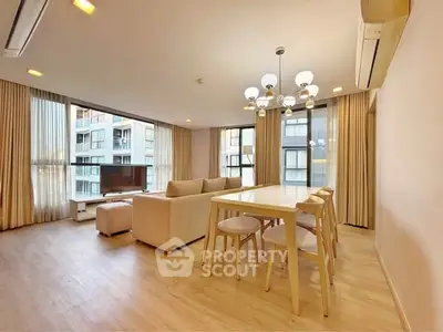 Spacious modern living room with elegant dining area and large windows