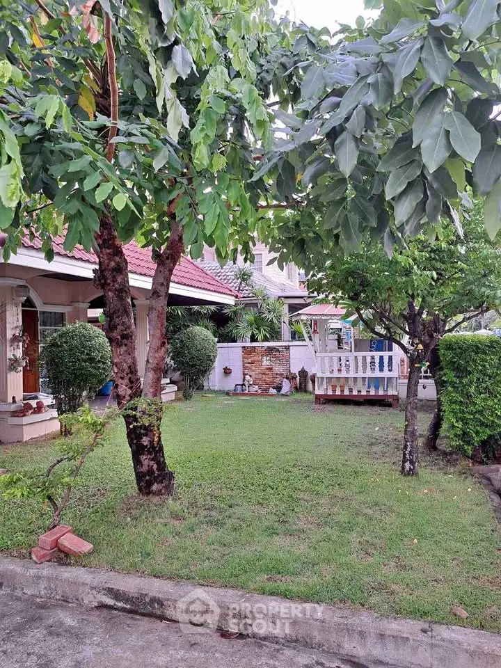 Charming suburban home with lush garden and inviting front porch, perfect for family living.