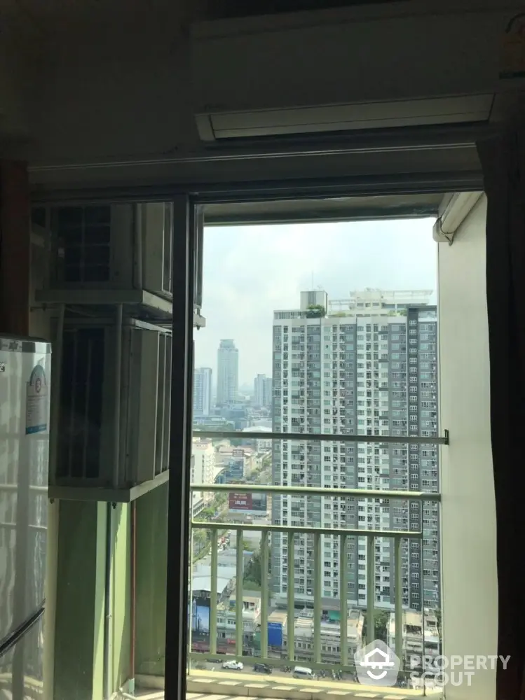 High-rise apartment view with balcony overlooking city skyline