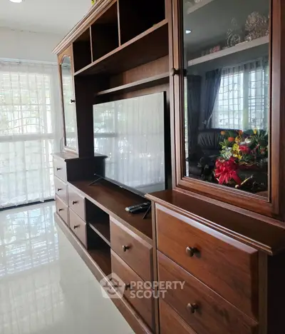 Spacious living room with elegant wooden furniture and natural light