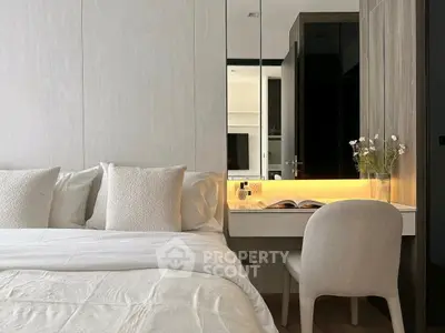 Elegant bedroom with cozy bed and stylish vanity area, perfect for relaxation and productivity.