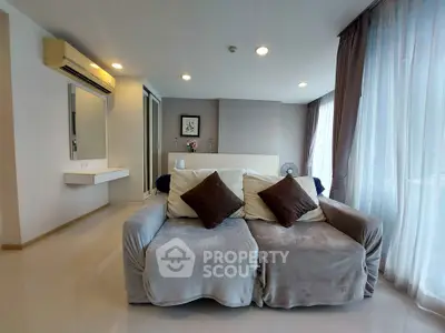 Spacious living room with cozy sofa and large windows in modern apartment
