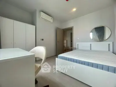 Modern minimalist bedroom with white furniture and air conditioning