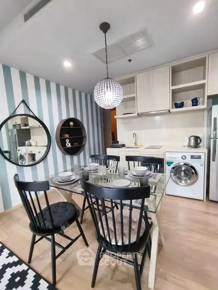 Modern kitchen with dining area featuring stylish decor and appliances, perfect for contemporary living.