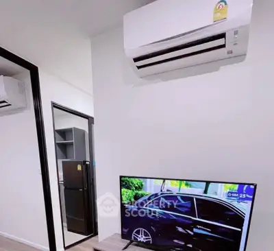 Modern apartment interior with air conditioning and flat-screen TV, showcasing sleek design and comfort.