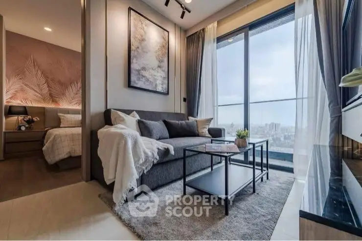 Modern living room with city view, stylish decor, and cozy ambiance in a high-rise apartment.