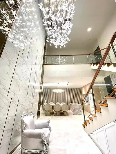 Luxurious modern living room with elegant chandelier and marble accents