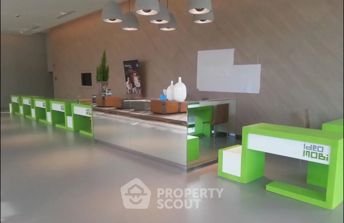 Modern real estate lobby with sleek green and white design, ideal for welcoming guests.