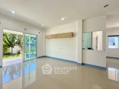 Spacious modern living room with large windows and garden view