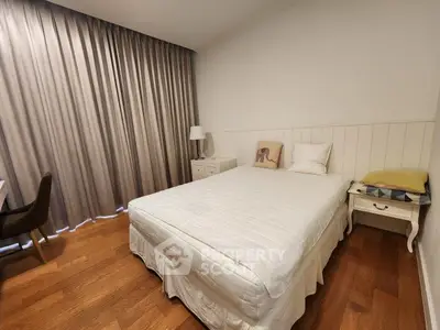 Cozy bedroom with elegant wooden flooring and stylish decor