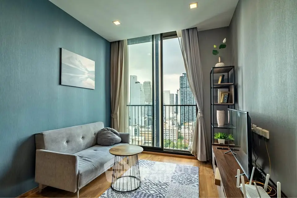 Modern living room with city view, stylish decor, and cozy seating area.