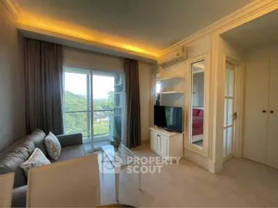 Charming living room with balcony view, modern decor, and natural light in a cozy apartment.