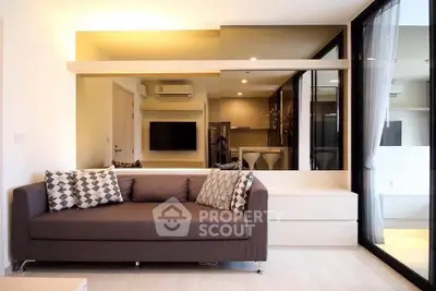 Modern living room with stylish sofa and large mirror enhancing space