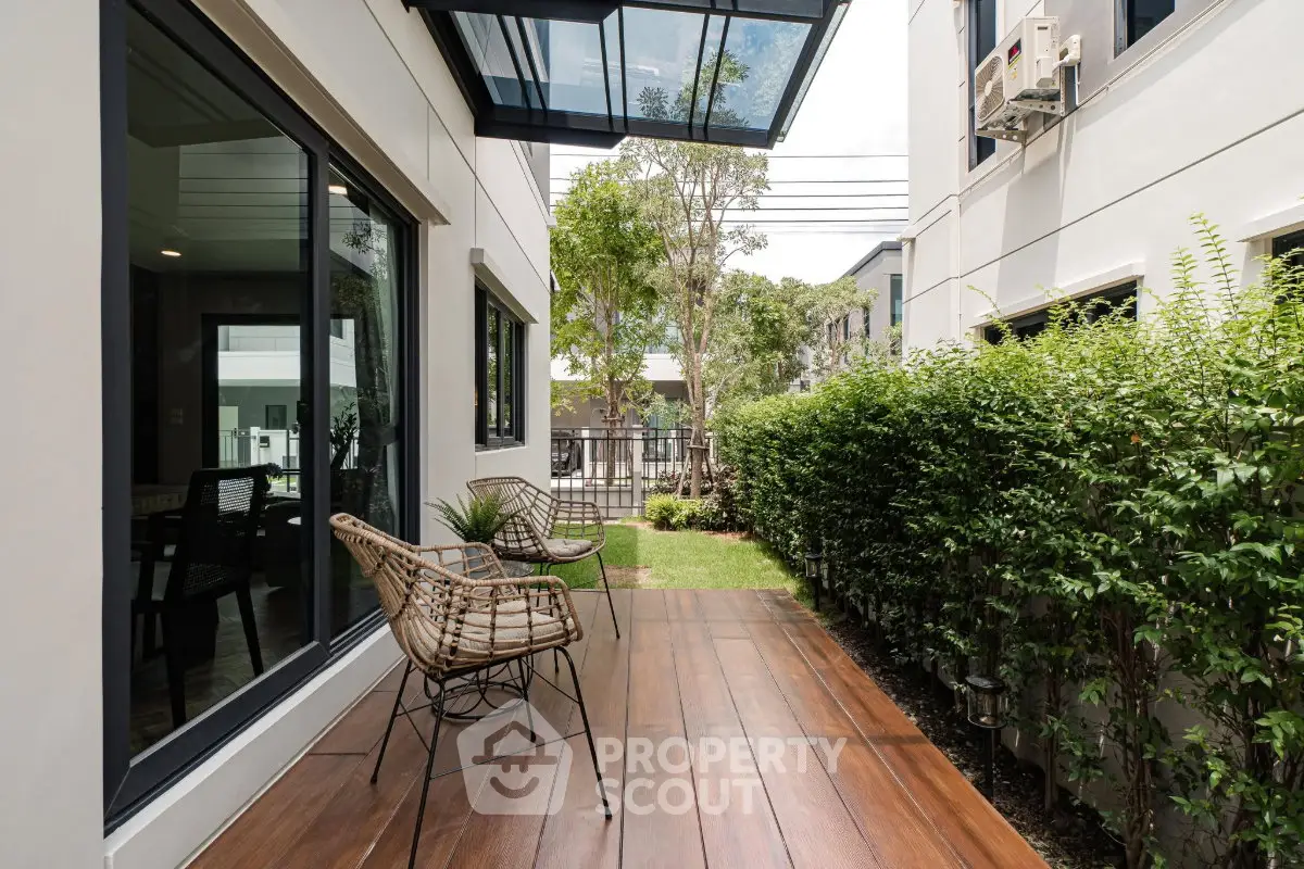 Charming outdoor patio with stylish seating and lush greenery, perfect for relaxation and entertaining.