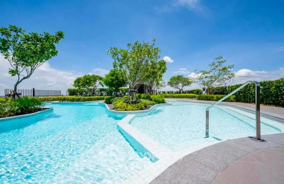 Luxurious rooftop pool with stunning views and lush greenery, perfect for relaxation and leisure.