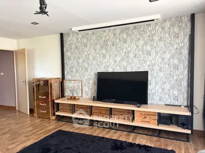 Modern living room with stylish TV stand and wooden flooring, perfect for cozy family gatherings.