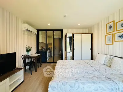 Modern studio apartment with cozy bedroom and open kitchen layout, featuring stylish decor and ample natural light.
