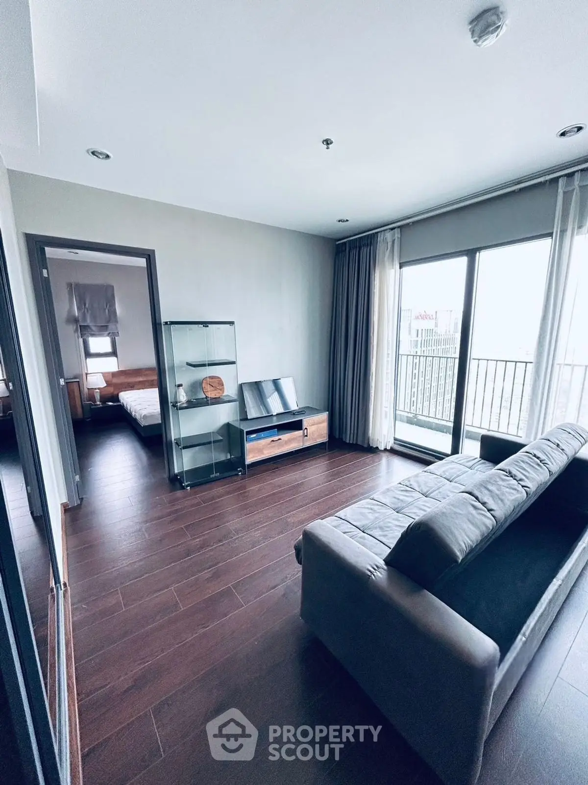 Modern living room with sleek furniture and balcony view