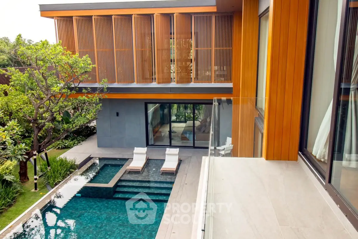 Luxurious modern home with private pool and elegant wooden facade, perfect for serene living.